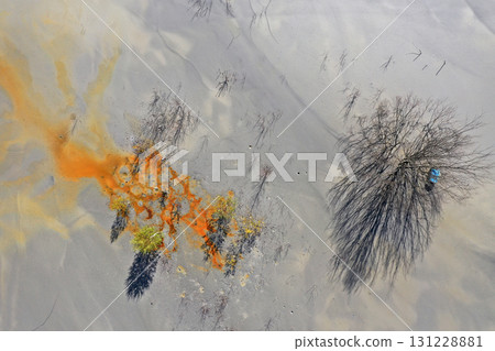 Aerial view of surreal natural patterns of gold cyanide leaching flowing into decanting lake Aerial view of surreal natural patterns of gold cyanide leaching flowing into decanting lake 131228881