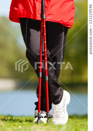 Nordic walking. Female legs hiking in the park. 131229546