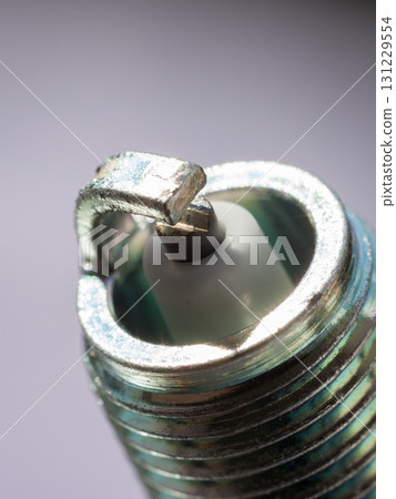 Auto service. New spark plug as spare part of car. Auto service. New spark plug as spare part of car. 131229554
