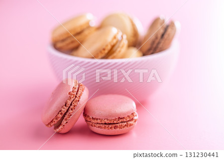 Different flavors of macarons. Colourful macaroons on pink background. 131230441