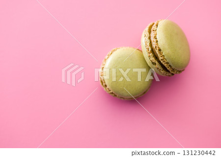 Different flavors of macarons. Colourful macaroons on pink background. Top view. 131230442