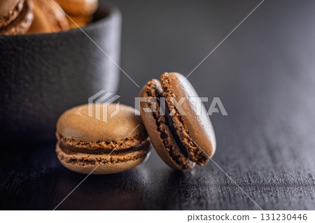 Different flavors of macarons. Colourful macaroons on black table. 131230446