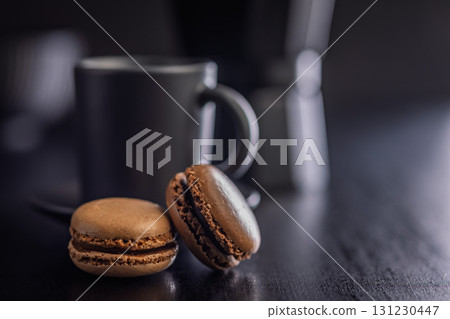 Different flavors of macarons. Colourful macaroons on black table. 131230447