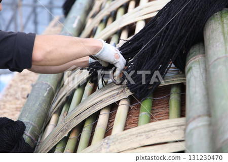 craftsman making roof decorations 131230470