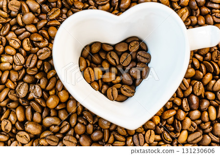 Heart shaped cup on coffee background 131230606