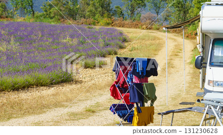 Clothes hanging to dry outdoors by camping car. Caravan vacation in France Clothes hanging to dry outdoors by camping car. Caravan vacation in France 131230628
