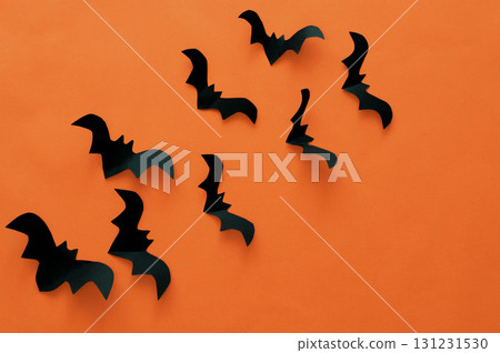 Halloween concept, black paper bats on an orange background 131231530