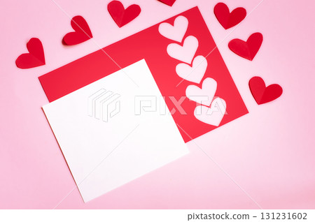 postcard, on a pink background red paper with hearts and white sheet for text postcard, on a pink background red paper with hearts and white sheet for text 131231602