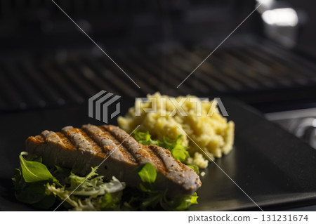 tuna fish steak with couscous and salad 131231674