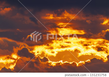 Dramatic fiery sunset sky with glowing clouds 131231758