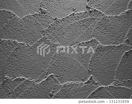 A horizontal background image of a dark gray earthen wall with trowel marks 131231939