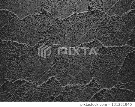 A horizontal background image of a charcoal-colored earthen wall with trowel marks remaining 131231940