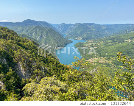 Canyon river meandering among green forested mountains; nature landscape photography 131232644