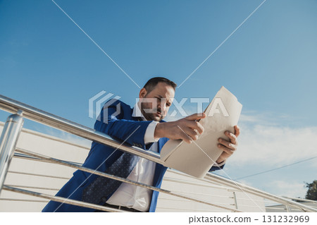 Entrepreneur Analyzing An Important Document Outdoor  131232969