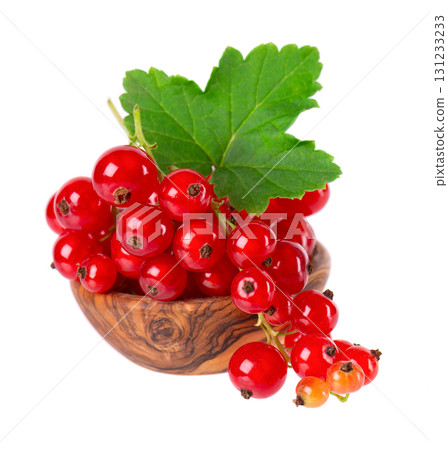 Red currant isolated on white background. Redcurrant or Ribes rubrum ripe berries with green leaves in wooden bowl. Red currant isolated on white background. Redcurrant or Ribes rubrum ripe berries with green leaves in wooden bowl. 131233233