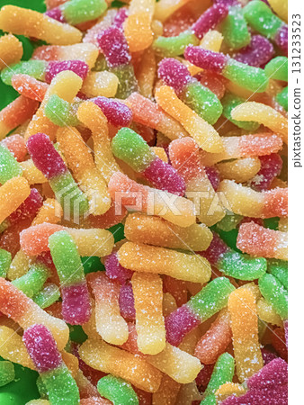 background of multi-colored, green and orange gummy candies worms close-up background of multi-colored, green and orange gummy candies worms close-up 131233523