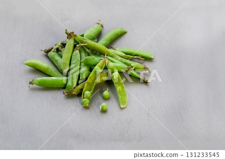 green peas fresh vegetables scattering on gray background green peas fresh vegetables scattering on gray background 131233545