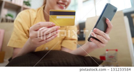 Online Shopping. Young woman using smartphone and credit card for e-commerce purchase. Online Shopping. Young woman using smartphone and credit card for e-commerce purchase. 131233584