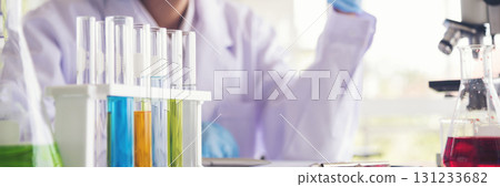Banner Asian woman scientist hand write note research in medical lab look at science microscope. Panorama biology chemistry lab. Asian Female technician laboratory using microscope with copy space 131233682
