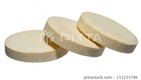 Stack of large round pills of light yellow color, isolated background Stack of large round pills of light yellow color, isolated background 131233796