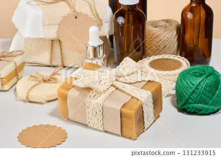 Handmade body care items, natural soap, wrapped in kraft paper and decorated with a crocheted ribbon. 131233915