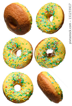 Yellow glazed donuts, each decorated with multi colored sprinkles. Yellow glazed donuts, each decorated with multi colored sprinkles. 131233917