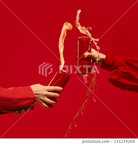 Two red cans collide with beer splash on vibrant red background full of energy. Mockup for text, ad Two red cans collide with beer splash on vibrant red background full of energy. Mockup for text, ad 131234268
