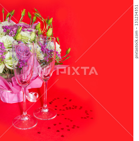 Valentine day romantic flat lay image. Wine glasses, heart shaped candles and red roses with red ribbon on white wooden background. Valentine day romantic flat lay image. Wine glasses, heart shaped candles and red roses with red ribbon on white wooden background. 131234351