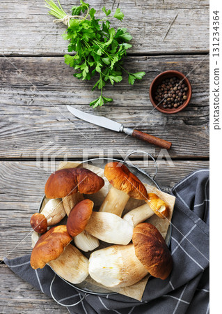wild porcini mushrooms, ceps on a round metal tray 131234364