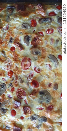 Homemade tomato and mushroom frittata closeup, fresh from oven. Mobile photography, real phone snapshot Homemade tomato and mushroom frittata closeup, fresh from oven. Mobile photography, real phone snapshot 131234920