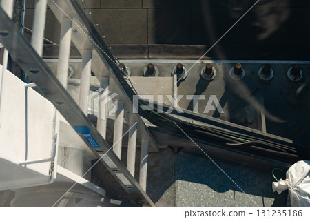 Exploring the heights with a ladder against a backdrop of urban architecture and tools on a sunny day 131235186