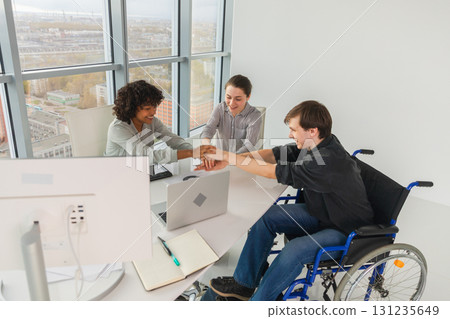 Stack of hands. Business startup teamwork unity concept. Top view of diverse multiracial business people putting hands together. Business colleagues during work process rejoice in success of company Stack of hands. Business startup teamwork unity concept. Top view of diverse multiracial business people putting hands together. Business colleagues during work process rejoice in success of company 131235649