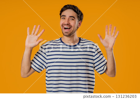 Friendly 20s aged man Waving Hand - Hello, Hi, salute, chao. Greetings on yellow Friendly 20s aged man Waving Hand - Hello, Hi, salute, chao. Greetings on yellow 131236203