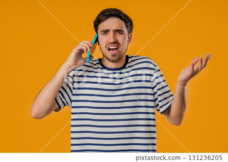 Angry Handsome Man Quarreling, Screaming Talking On Mobile Phone. Guy In Studio Angry Handsome Man Quarreling, Screaming Talking On Mobile Phone. Guy In Studio 131236205