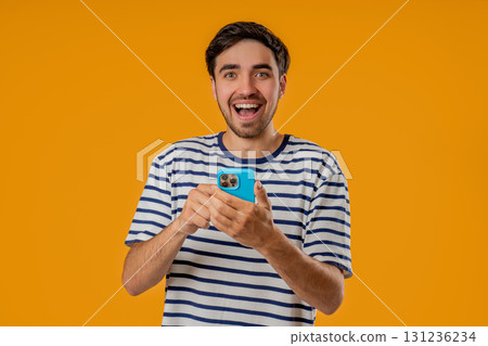 Handsome man surfing internet on smartphone. Guy using social networks, chatting 131236234