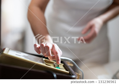 Close up of a therapists hand adjusting the settings on an electrotherapy machine before physiotherapy treatment. Concept of modern rehabilitation, medical technology, and therapeutic healthcare 131236561