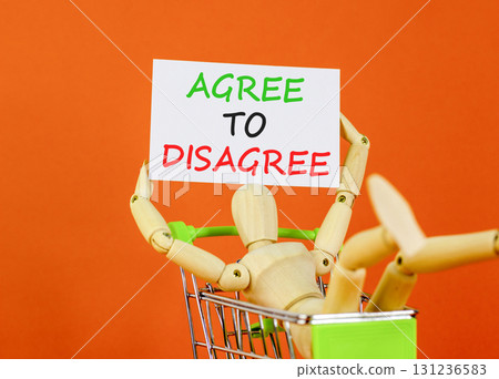 Agree to disagree symbol. Concept words Agree to disagree on beautiful white card. Beautiful orange background. Businessman model in shop cart. Business and agree to disagree concept. Copy space. 131236583