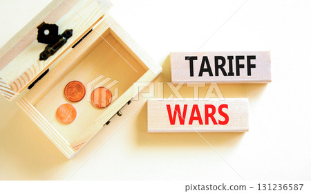 Trade tariff wars symbol. Concept word Tariff wars on beautiful wooden blocks. Beautiful white paper background. Beautiful wooden chest with coins. Business trade tariff wars concept. Copy space. 131236587
