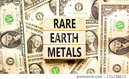 Rare earth metals symbol. Concept words Rare earth metals on beautiful wooden blocks. Dollar bills. Beautiful background from dollar bills. Business and rare earth metals concept. Copy space. 131236615
