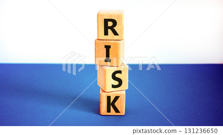 Risk symbol. Concept word Risk on beautiful wooden blocks. Beautiful white and blue background. Business, lifestyle, support and risk concept. Copy space. Risk symbol. Concept word Risk on beautiful wooden blocks. Beautiful white and blue background. Business, lifestyle, support and risk concept. Copy space. 131236650