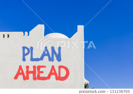 Plan ahead symbol. Concept word Plan ahead on beautiful white wall. Beautiful blue sky background. Business plan ahead concept. Copy space. 131236705
