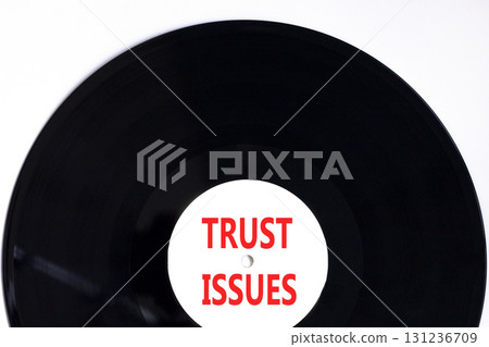 Trust issues symbol. Concept word Trust issues on beautiful black and white vinyl disk. Beautiful white paper background. Business trust issues concept. Copy space. Trust issues symbol. Concept word Trust issues on beautiful black and white vinyl disk. Beautiful white paper background. Business trust issues concept. Copy space. 131236709