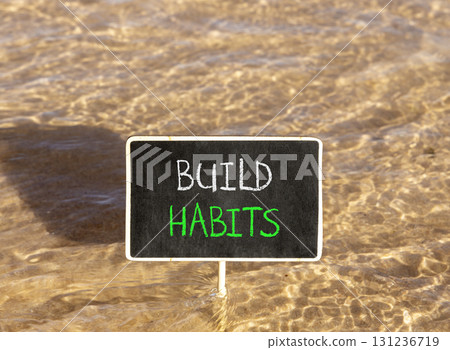 Build habits symbol. Concept word Build habits on beautiful black blackboard. Beautiful Red sea water background. Black blackboard. Business build habits concept. Copy space. 131236719