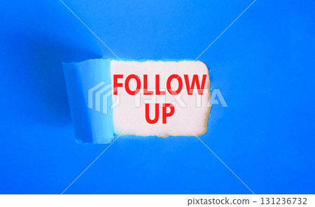 Follow up symbol. Concept word Follow up on beautiful white paper. Beautiful blue paper background. Business follow up concept. Copy space. 131236732