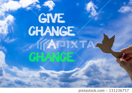 Give change a chance symbol. Concept words phrase Give change a chance on blue sky. Businessman's hand. Beautiful blue sky clouds background. Business Give change a chance concept. Copy space. Give change a chance symbol. Concept words phrase Give change a chance on blue sky. Businessman's hand. Beautiful blue sky clouds background. Business Give change a chance concept. Copy space. 131236757