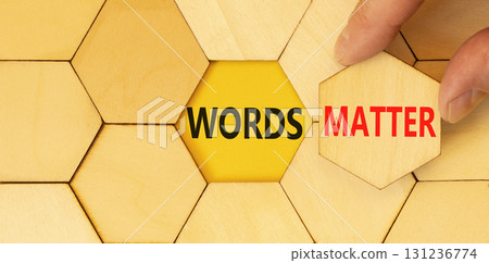 Words matter symbol. Concept word Words matter on beautiful wooden puzzles. Businessman's hand. Beautiful yellow paper background. Business words matter concept. Copy space. 131236774