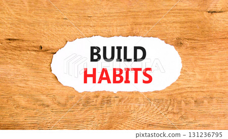Build habits symbol. Concept word Build habits on beautiful white paper. Beautiful wooden paper background. Business build habits concept. Copy space. Build habits symbol. Concept word Build habits on beautiful white paper. Beautiful wooden paper background. Business build habits concept. Copy space. 131236795