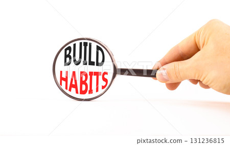 Build habits symbol. Concept word Build habits on beautiful magnifying glass. Businessman's hand. Beautiful white paper background. Black magnifying glass. Business build habits concept. Copy space. 131236815