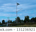 Colorful festive pennant flags hanging on string among green summer trees creating simple cheerful decoration symbolizing outdoor holiday celebration and relaxed seasonal atmosphere 131236921