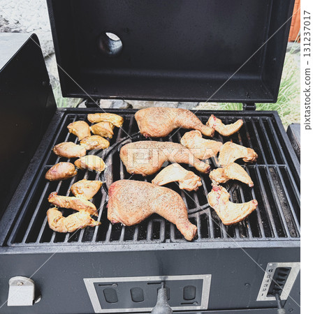 Chicken wings grilled on the grill in a BBQ grate Chicken wings grilled on the grill in a BBQ grate 131237017